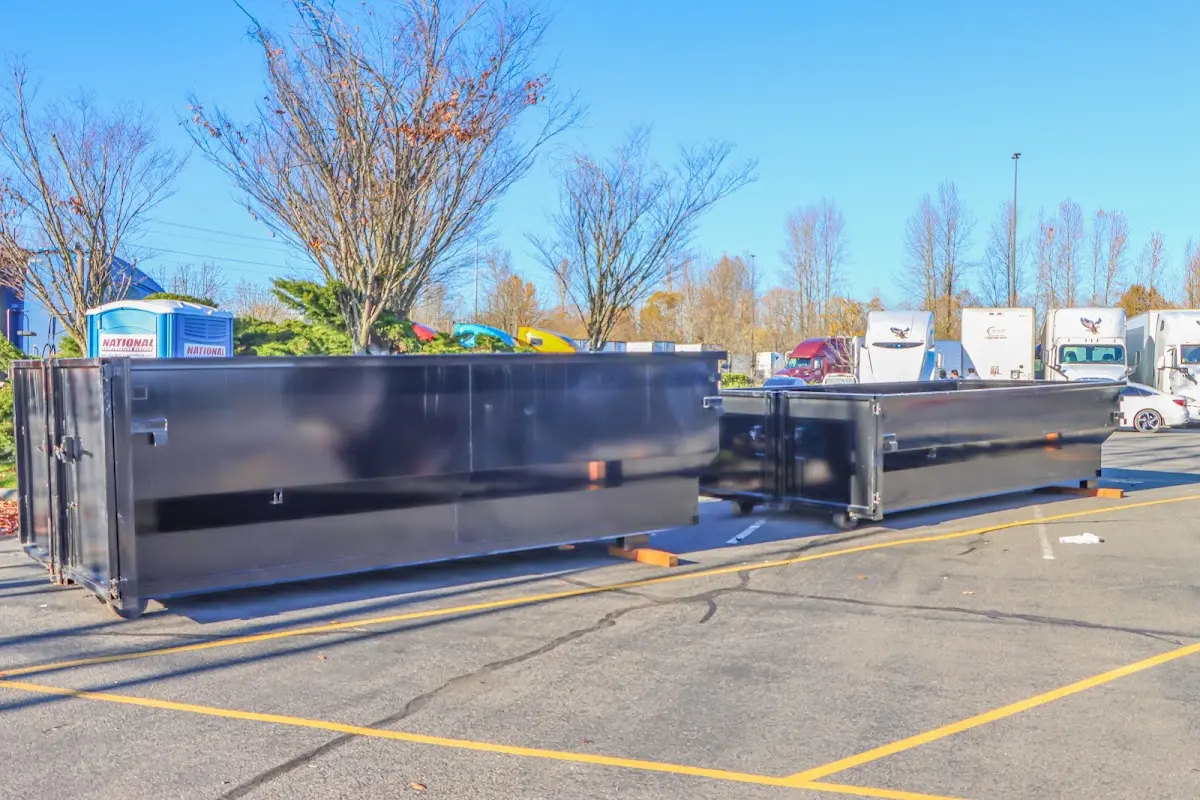 Professional dumpster rental service with roll-off container on residential driveway in Sturbridge